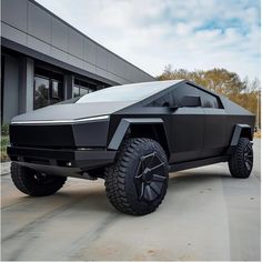 a futuristic vehicle parked in front of a building