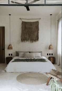 a bedroom with a bed, rugs and hanging lights
