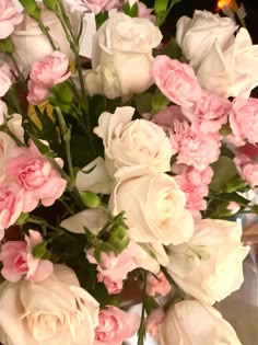 pink and white flowers in a vase on a table