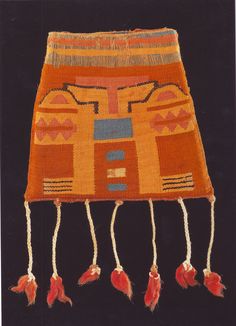 an orange and blue rug with tassels on the ends, hanging from it's sides