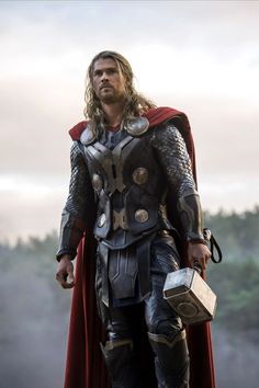 a man dressed as thor stands in front of the sky with his hands on his hips