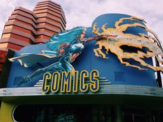 the sign on the side of a building that says conicc with an image of a dragon flying over it