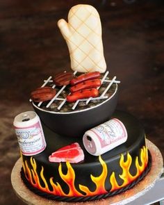 a cake with hot dogs and marshmallows on top is decorated like a grill