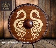 a wooden plaque with two dragon designs on it