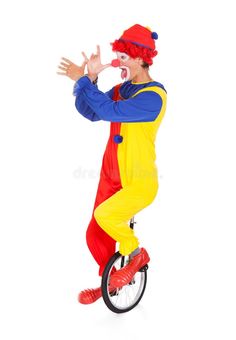 a man in clown costume riding on a unicycle with his hands up