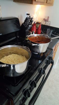 two pans of food are sitting on the stove, one is being cooked and the other is cooking