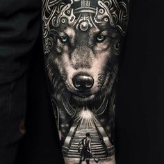 a man with a wolf tattoo on his arm