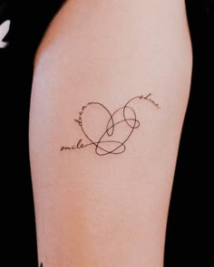 a woman's arm with a tattoo on it that says love is in the air