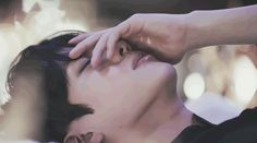 a woman is holding her head to her ear