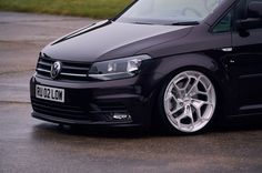 a black van parked on top of a parking lot
