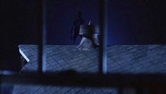 a person standing on top of a roof at night