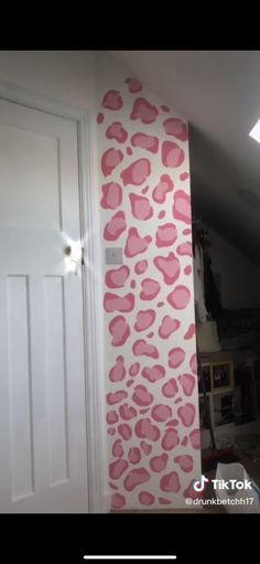 the wall is painted with pink hearts on it