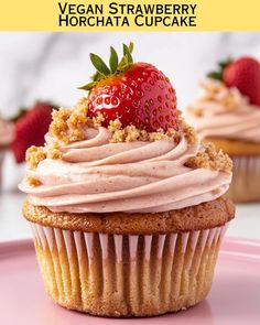 there is a cupcake with frosting and strawberries on top that says vegan strawberry horchata cupcake