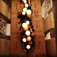 the table is set with candles and place mats for guests to sit down at it