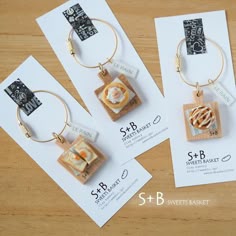 three different types of earrings sitting on top of each other next to some cards and envelopes