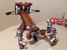 Roman heavy Ballista. Yes this does really shoot too! Just needs some tweaking to the rubber bands to increase range. Time for another siege MOC I think🤔 #lego #customminifig #legominifigures #legominifigure #legomoc #legoroman #rome #romans #republicanrome #gallicwars #juliuscaesar #ancientrome #ancienthistory #ballista Lego Ballista, Lego Roman Building Ideas, Lego Roman City, Lego Ancient Rome, Lego Roman Battle Scene, Lego Roman Army Formation, Lego Battering Ram, Lego Roman Soldiers Formation, Lego Roman Army