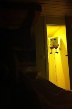 the door is open and there is a yellow light in the room