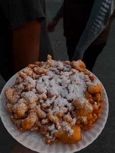 a white plate topped with powdered sugar covered food