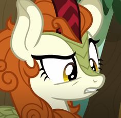 the pony is looking at something in front of her face and she has brown hair