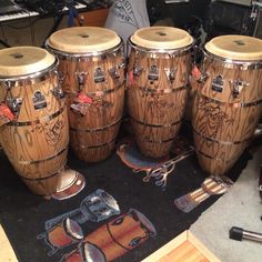 several wooden drums sitting on top of a rug