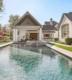 a house with a pool in front of it