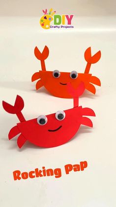 two paper crabs with googly eyes and the words rockin'pap on them
