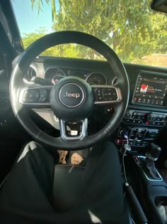 the interior of a car with steering wheel and dashboard