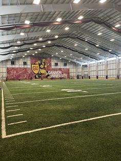 an empty football field in a large building