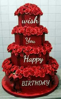 a three tiered red cake with roses on it and the words wish you happy birthday