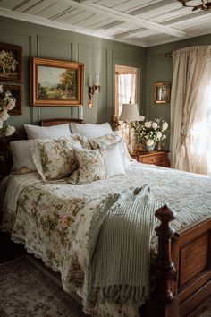 a large bed sitting in a bedroom next to two lamps and paintings on the wall
