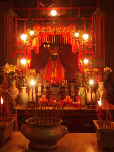 candles are lit in front of a shrine