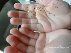 a baby's hand with gold flecks on it