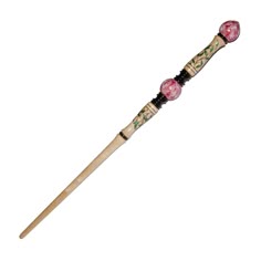 a wooden toothbrush with pink flowers on it's handle and black beads around the bristles