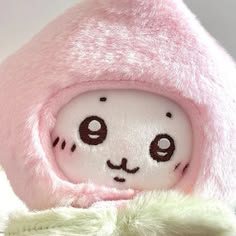 a close up of a stuffed animal wearing a pink hat