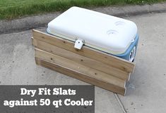 a cooler sitting on top of a wooden box with the words dry fit slats against it