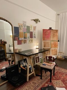 a living room filled with lots of furniture and art on the wall next to a mirror