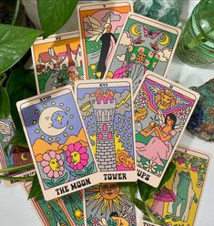 the moon tarot cards are surrounded by plants