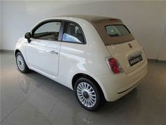 a small white car parked in a showroom