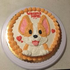 a birthday cake decorated with a dog's face and hearts on the bottom layer