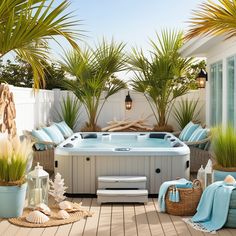 an outdoor hot tub surrounded by palm trees and wicker baskets with towels on it
