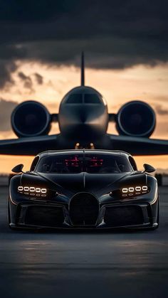 the bugatti supercar is parked in front of an airplane at sunset or dawn