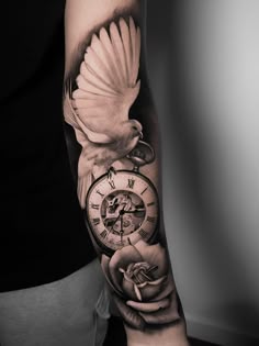a man's arm with a clock and bird on it