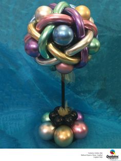 a sculpture made out of balloons on a blue background