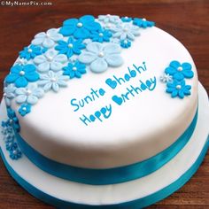 a birthday cake decorated with blue flowers and the words happy birthday