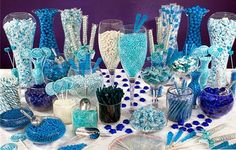 a table topped with lots of blue and white candy