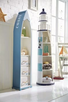 a blue and white boat shaped shelf next to an open bookcase in a room