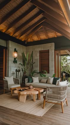 a living room filled with furniture on top of a hard wood flooring covered patio
