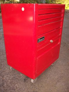a red tool box sitting on the ground