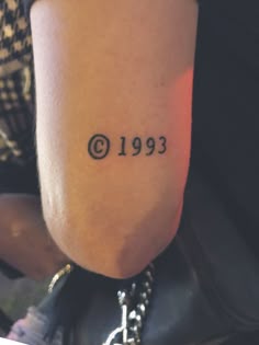 a person with a tattoo on their arm that reads, copyright 1933 and the number thirteen