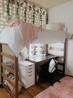 a loft bed with a desk underneath it and lots of lights on the wall behind it